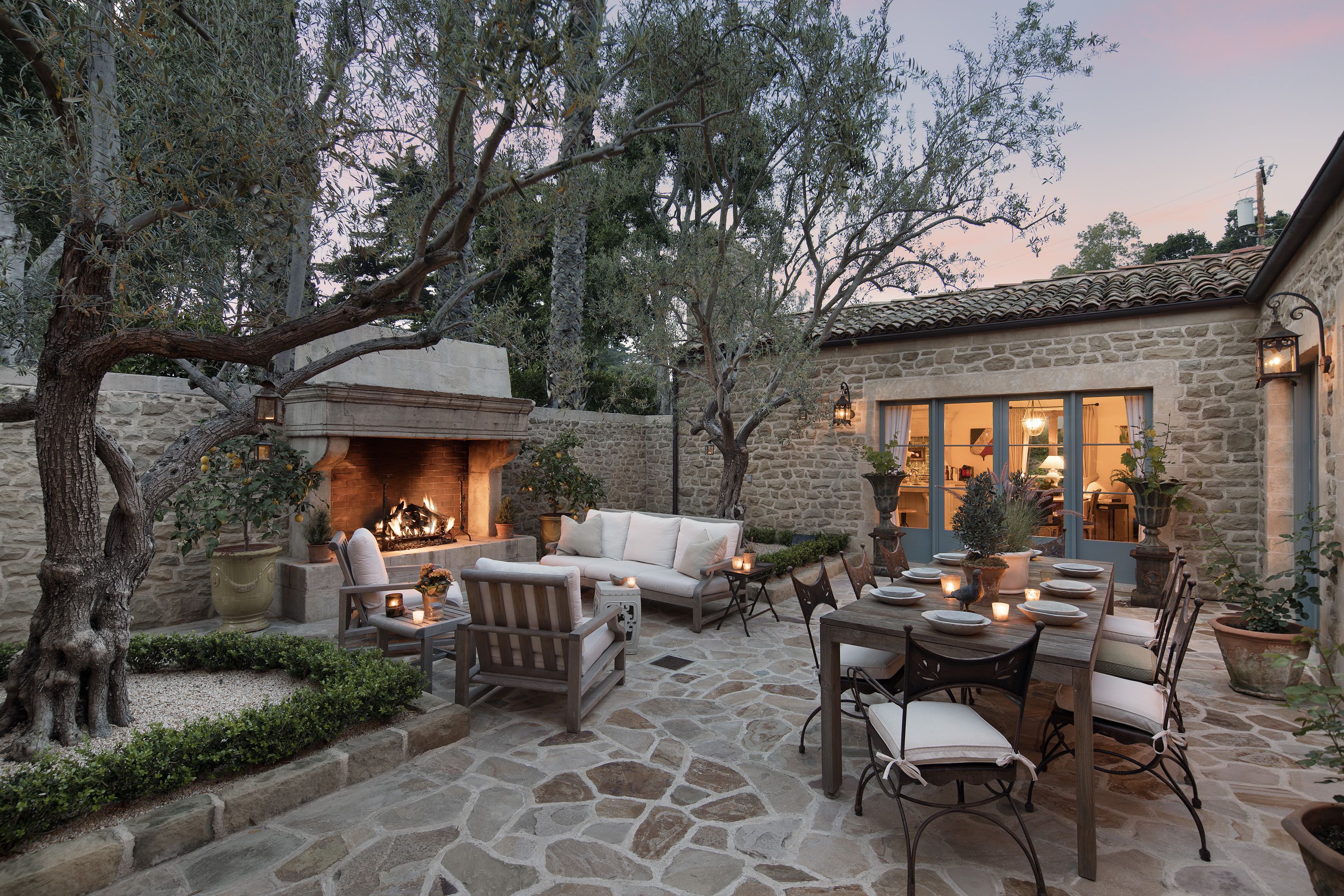 cozy outdoor patio with seating near fireplace